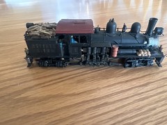 two truck pacfic fast mail shay with 2 weathered log cars and a gondola car