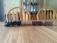two truck pacfic fast mail shay with 2 weathered log cars and a gondola car